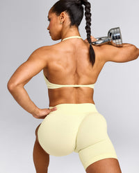 EnhanceLift™ Seamless Minimal Halter Neck Bralette with Grey Logo | Pastel Yellow