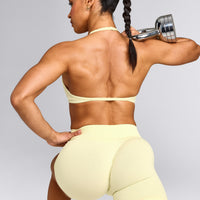 EnhanceLift™ Seamless Minimal Halter Neck Bralette with Grey Logo | Pastel Yellow