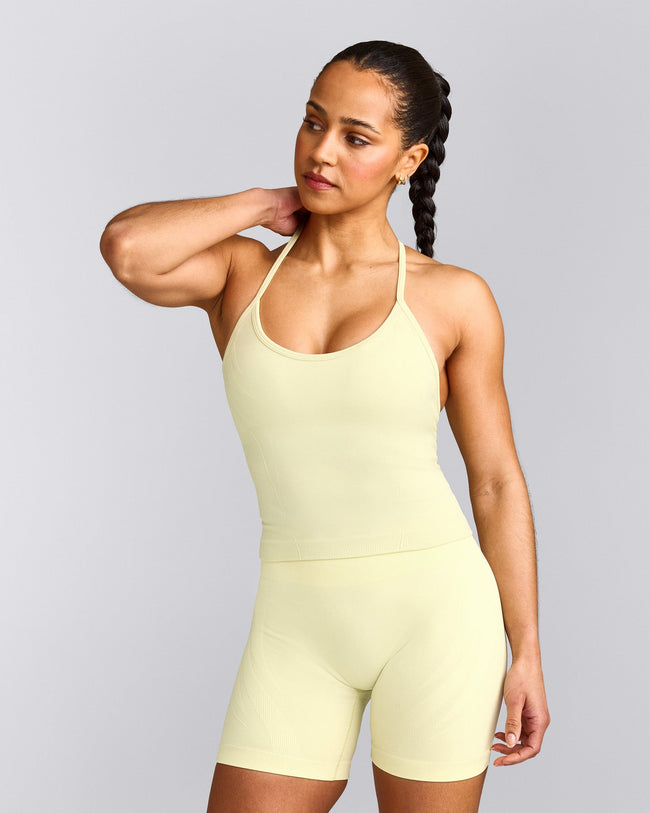 EnhanceLift™ Seamless Strappy Racer Vest with Built in Bra Shelf with Grey Logo | Pastel Yellow