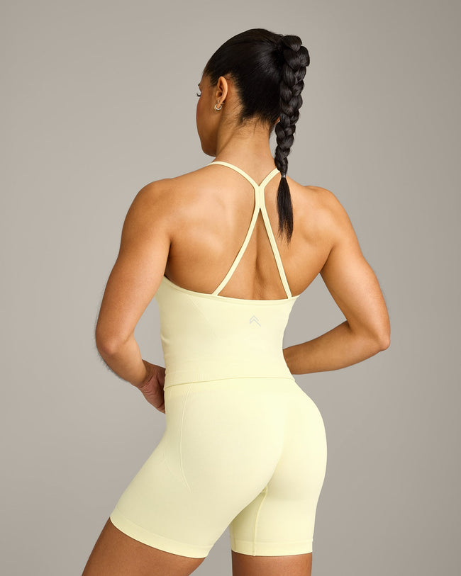 EnhanceLift™ Seamless Strappy Racer Vest with Built in Bra Shelf with Grey Logo | Pastel Yellow