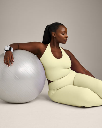 SoftMotion™ Halter Neck Mid Vest with Built in Bra Shelf with Grey Logo | Pastel Yellow