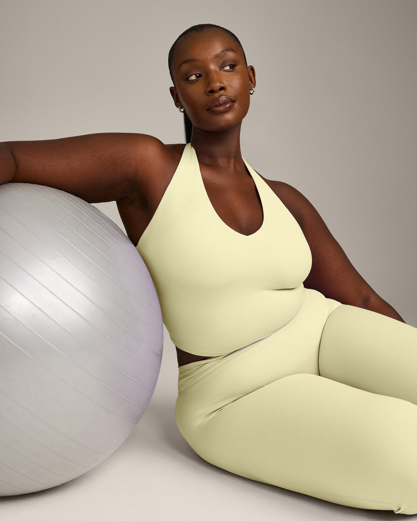SoftMotion™ Halter Neck Mid Vest with Built in Bra Shelf with Grey Logo | Pastel Yellow