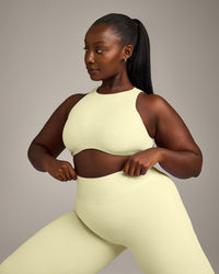 SoftMotion™ High Neck Sports Bra with Grey Logo | Pastel Yellow