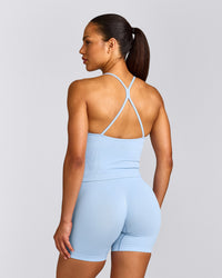 EnhanceLift™ Seamless Strappy Racer Tank Top with Built in Bra Shelf with Grey Logo | Powdered Blue