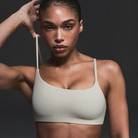 SoftMotion™ Strappy Sports Bra with Grey Logo | Oatmeal